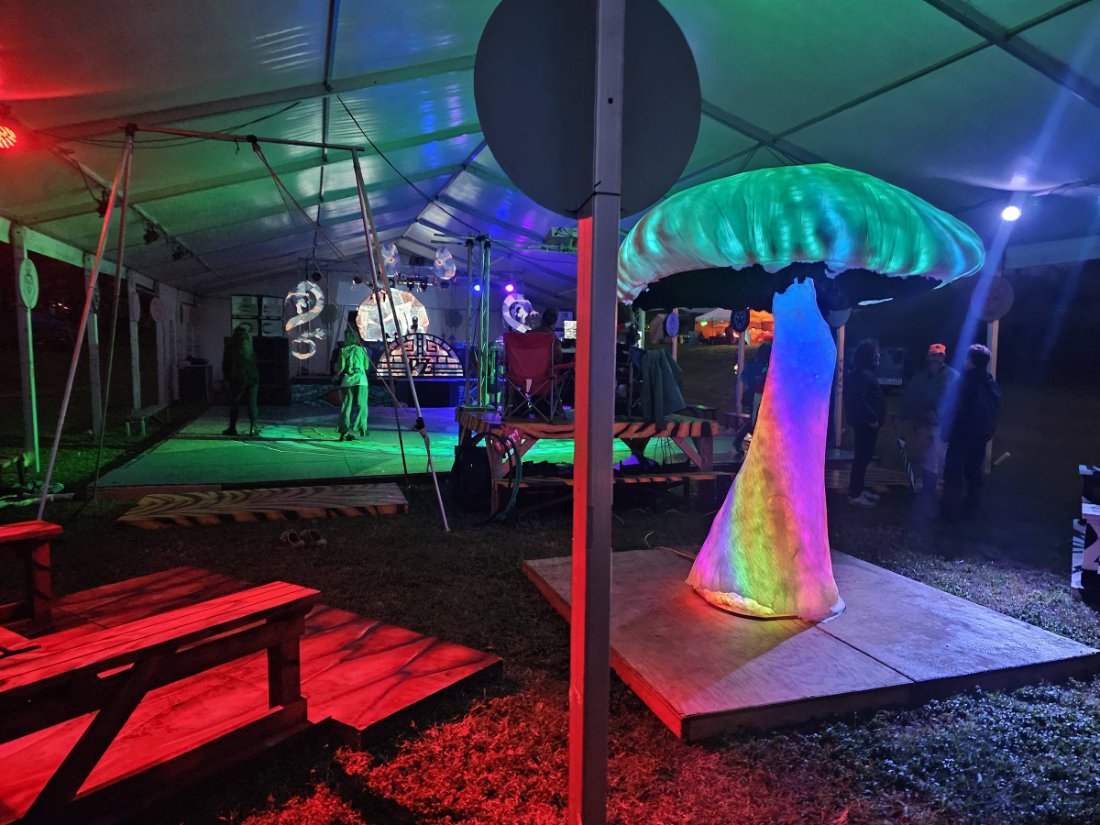 LED mushroom sculpture lit in teal and green at a Big Island tented event