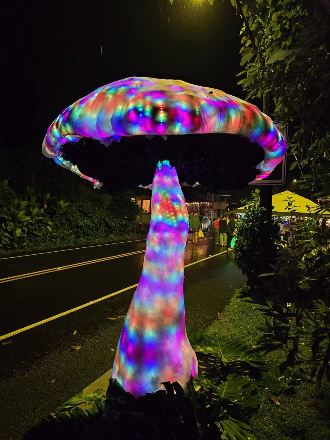 Nine-foot LED mushroom sculpture lit in rainbow colors at a Big Island night event